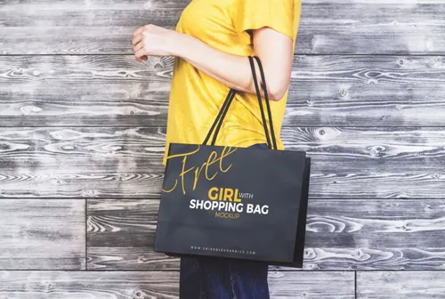 购物袋模型PSD贴图模板Girl With Shopping Bag MockUp Freebie on Antique Wooden