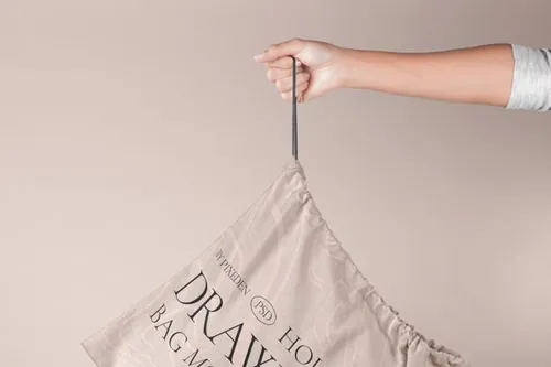 抽绳布袋包装设计展示样机模板 Hand Holding Psd Drawstring Bag Mockup